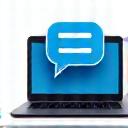 Person using a laptop with a chat bubble icon floating above it, symbolizing live chat support